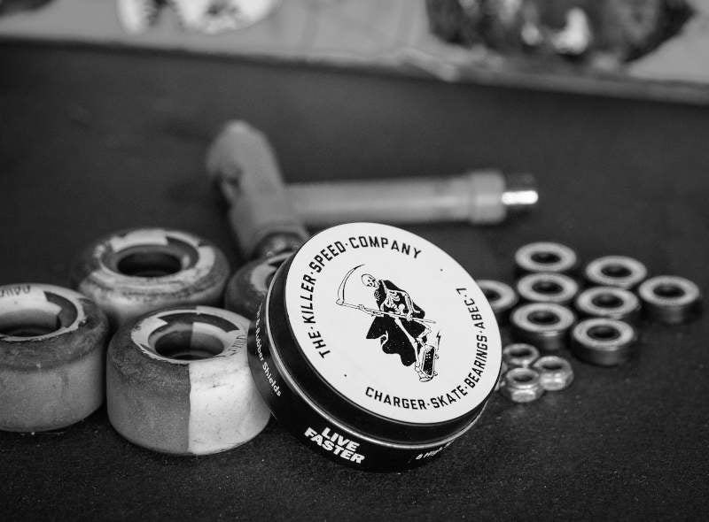 Killer Speed Co. ABEC 7 Charger Bearings laid out around a Skate Tool And Skateboard Wheels