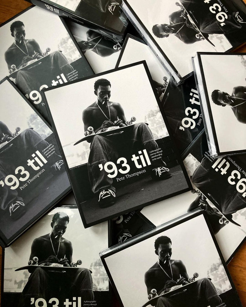 A stack of Pete Thomson's " '93 til: A Photographic Journey Through Skateboarding in the 1990s" book